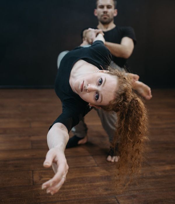 Man performing a controlled strength exercise in a bright studio.